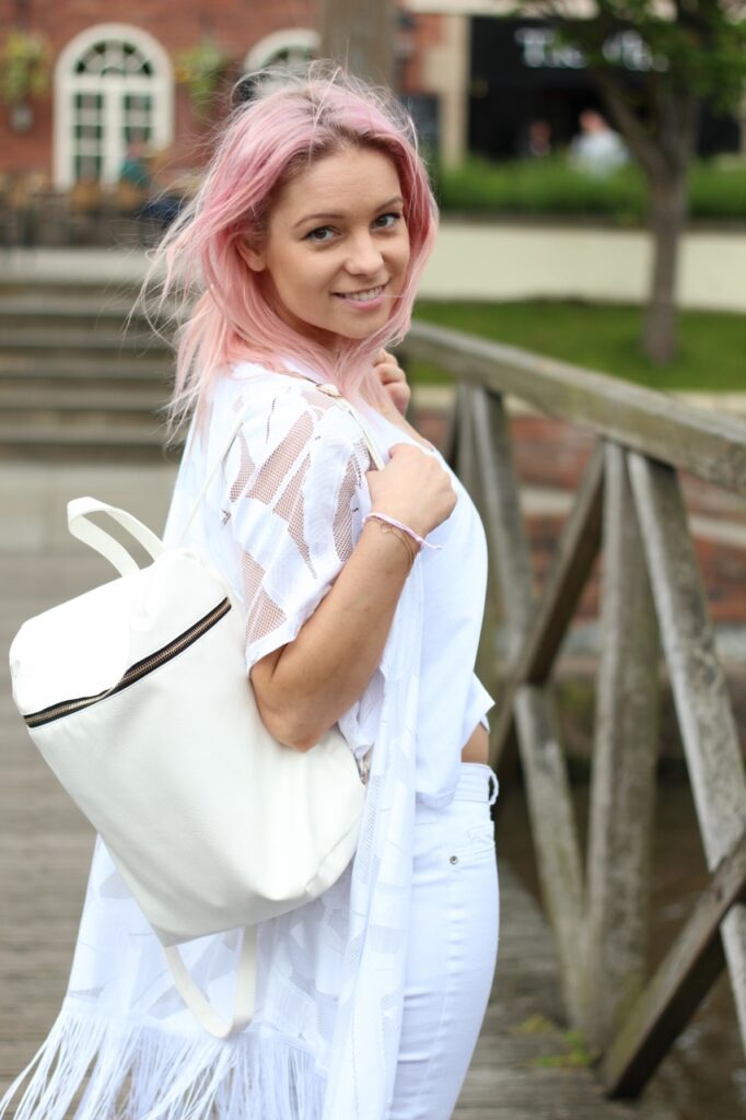 pastel pink hair girl with white backpack