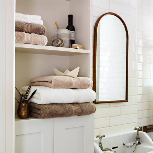 pastel towels and copper mirror